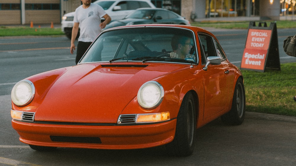 a red sports car parked in a parking lot