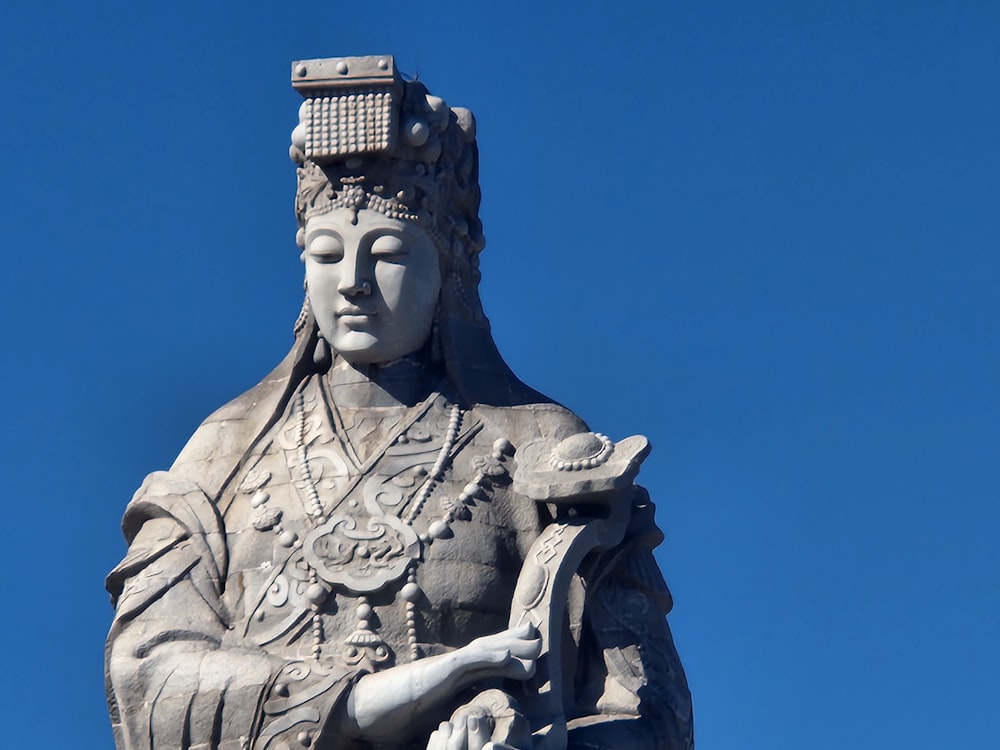 une statue d’une femme avec un panier sur la tête