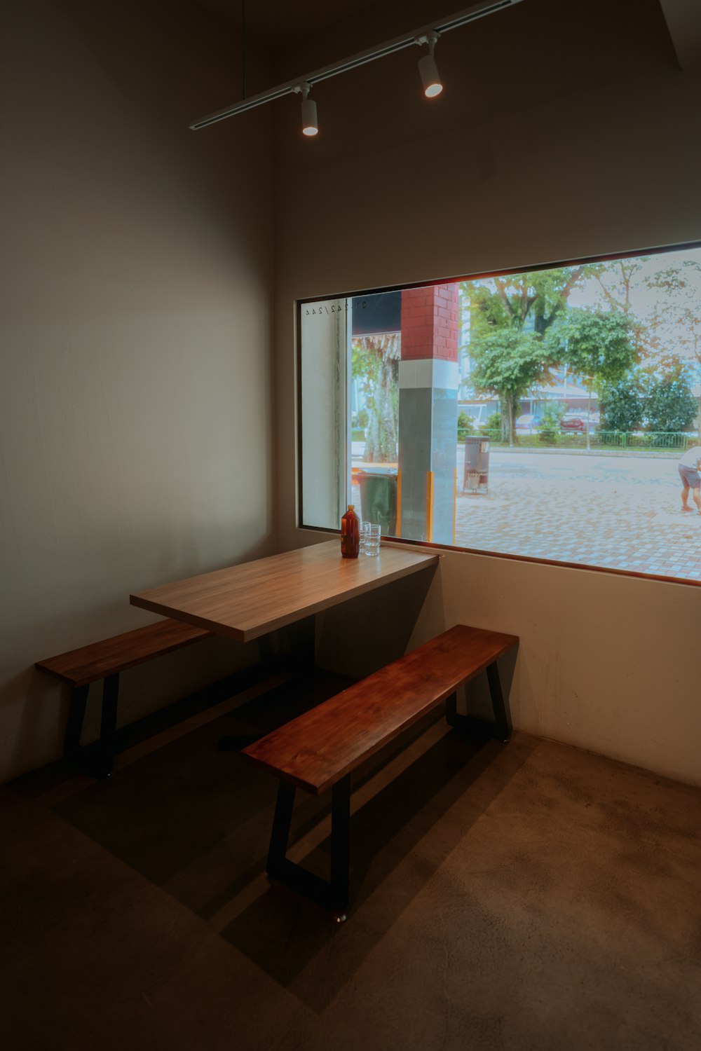 a wooden bench sitting in front of a window