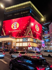a large building with a lot of cars parked in front of it