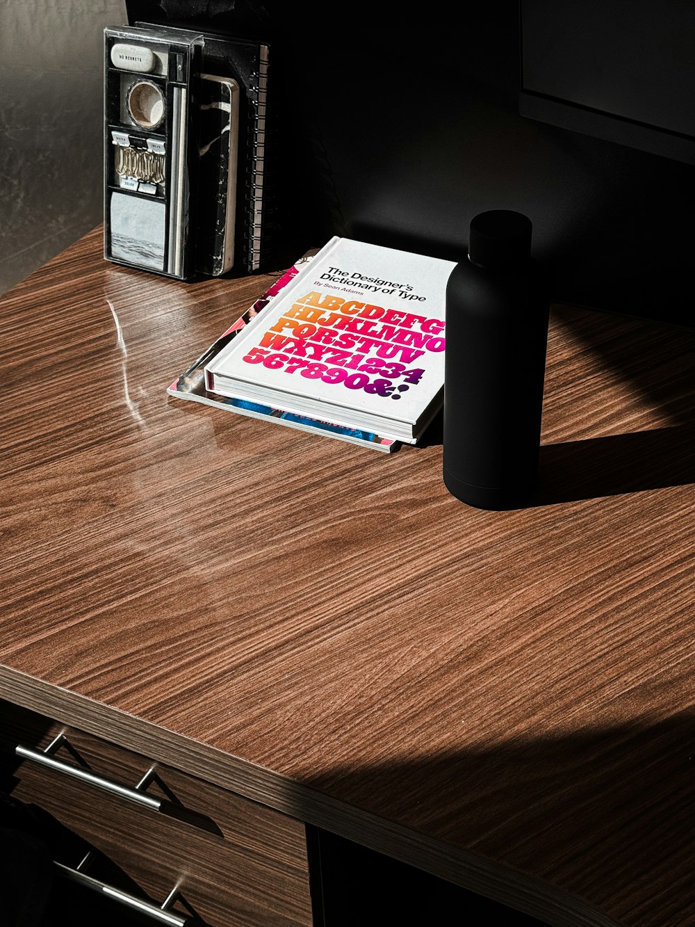 a table with a book and a radio on it