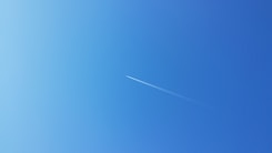 an airplane is flying high in the sky