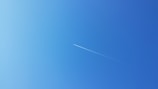 an airplane is flying high in the sky