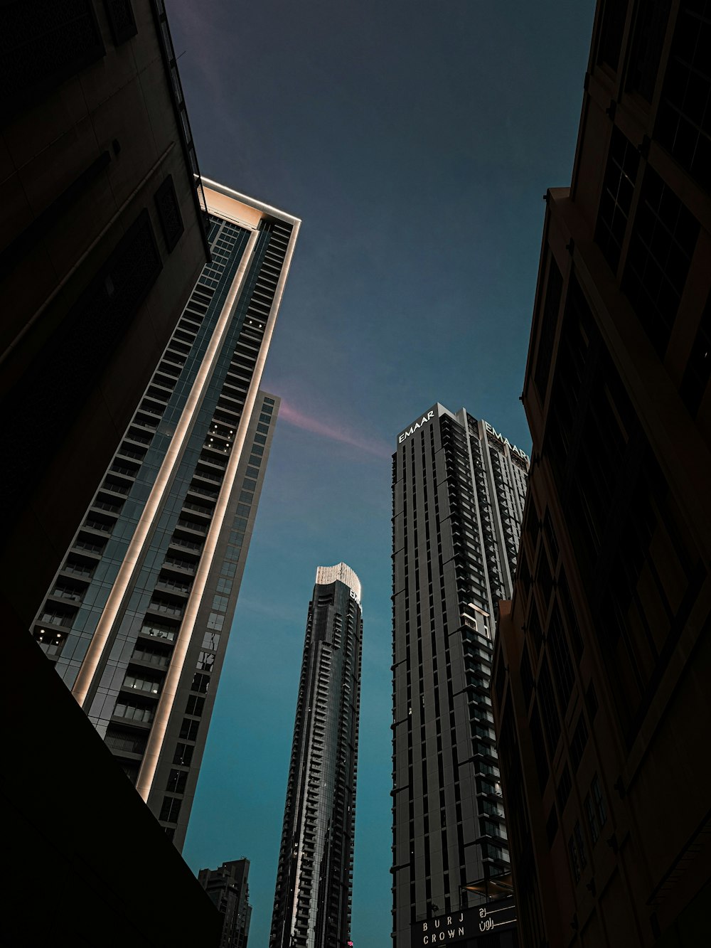 a couple of tall buildings sitting next to each other