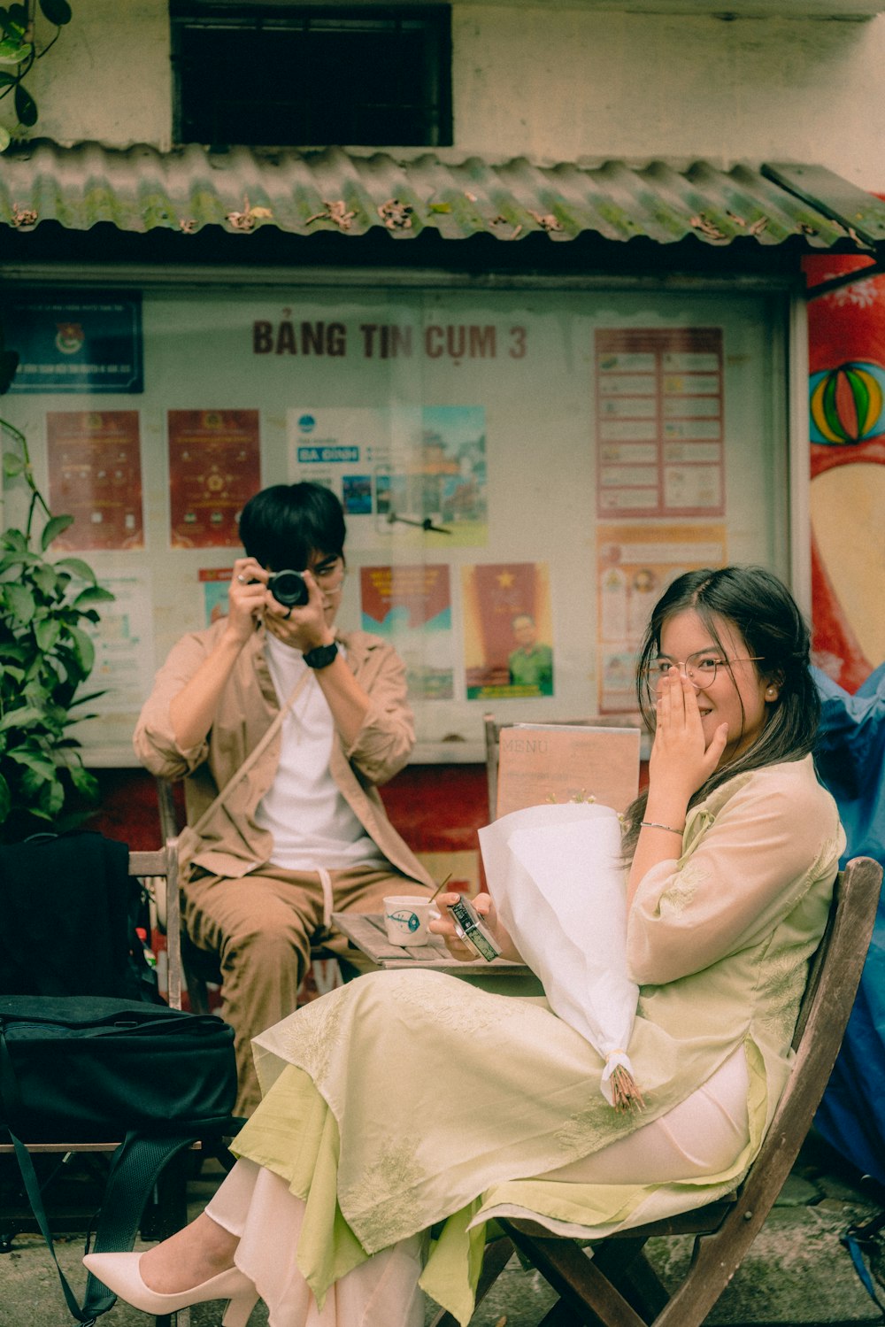 a woman sitting in a chair next to a man