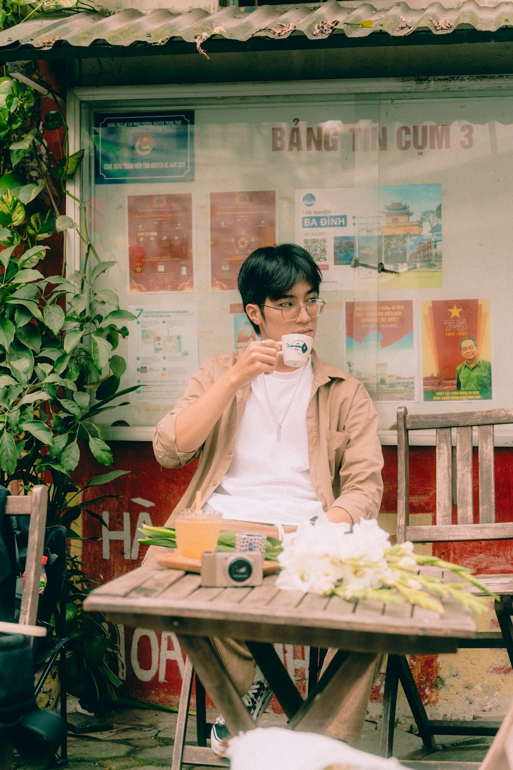 a man sitting at a table with a cup of coffee