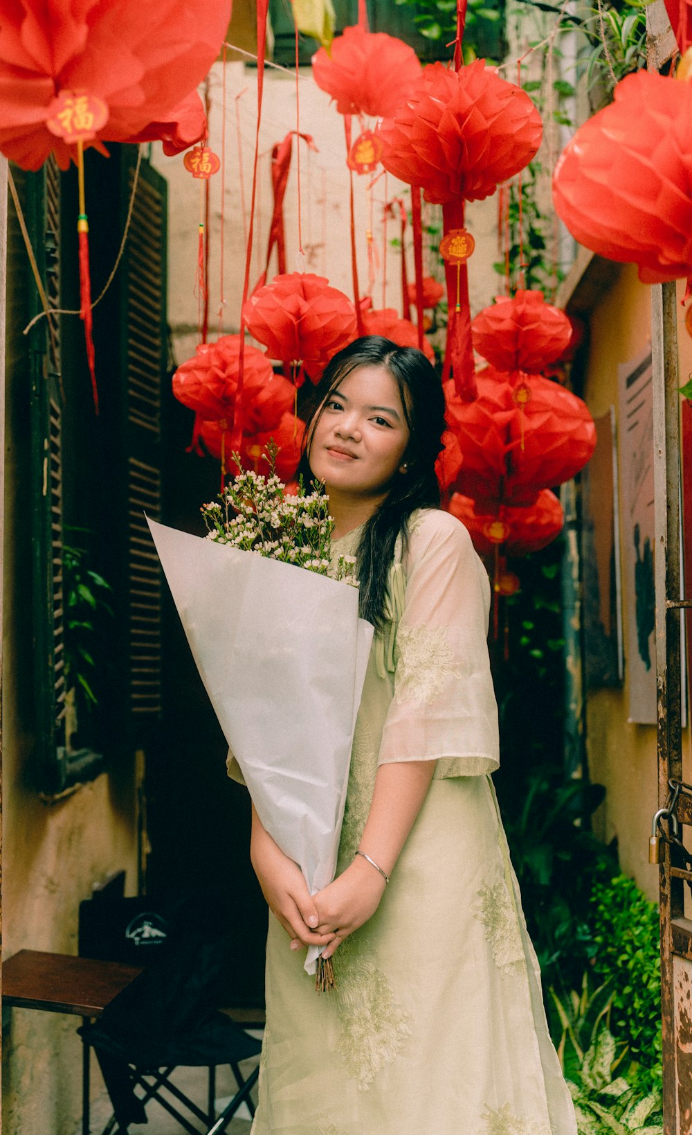 a woman is holding a bouquet of flowers