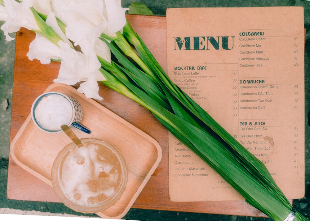 a menu and a drink on a table