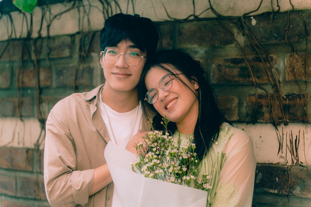 a man holding a bouquet of flowers next to a woman