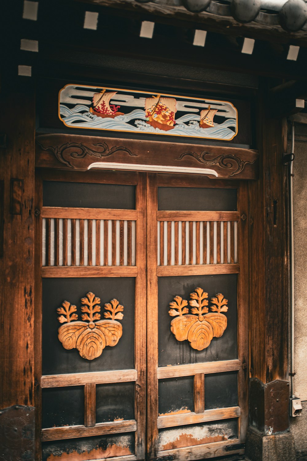 a pair of wooden doors with carved designs on them