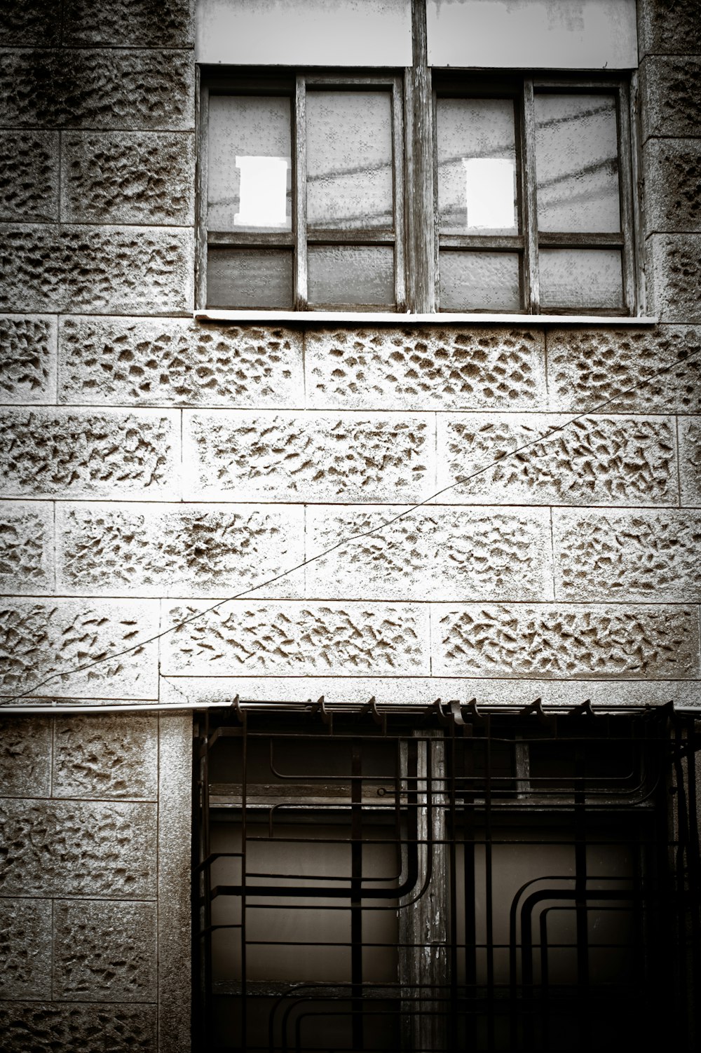 a building with a window and some bars in front of it