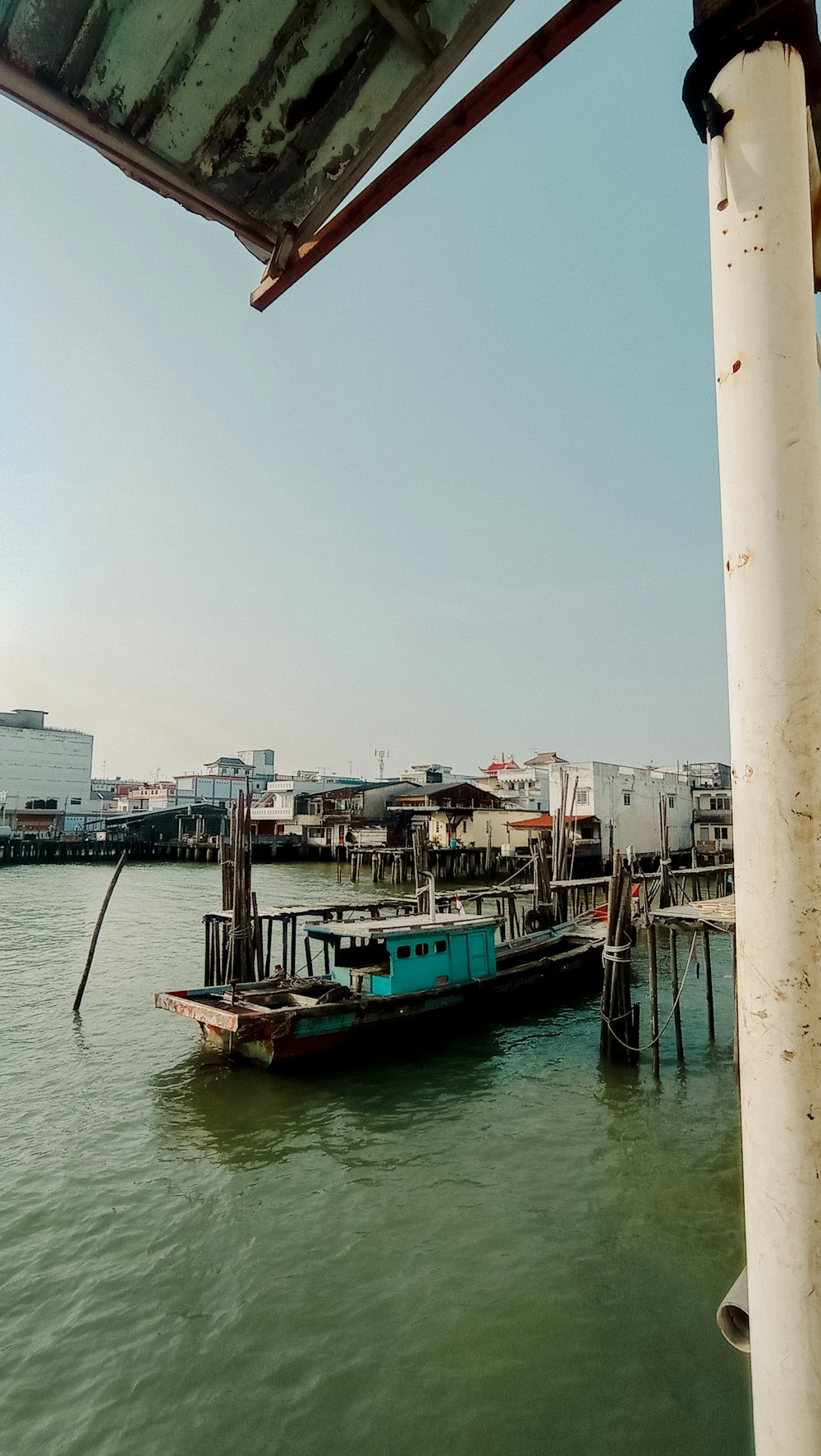 a boat is docked at a pier in the water