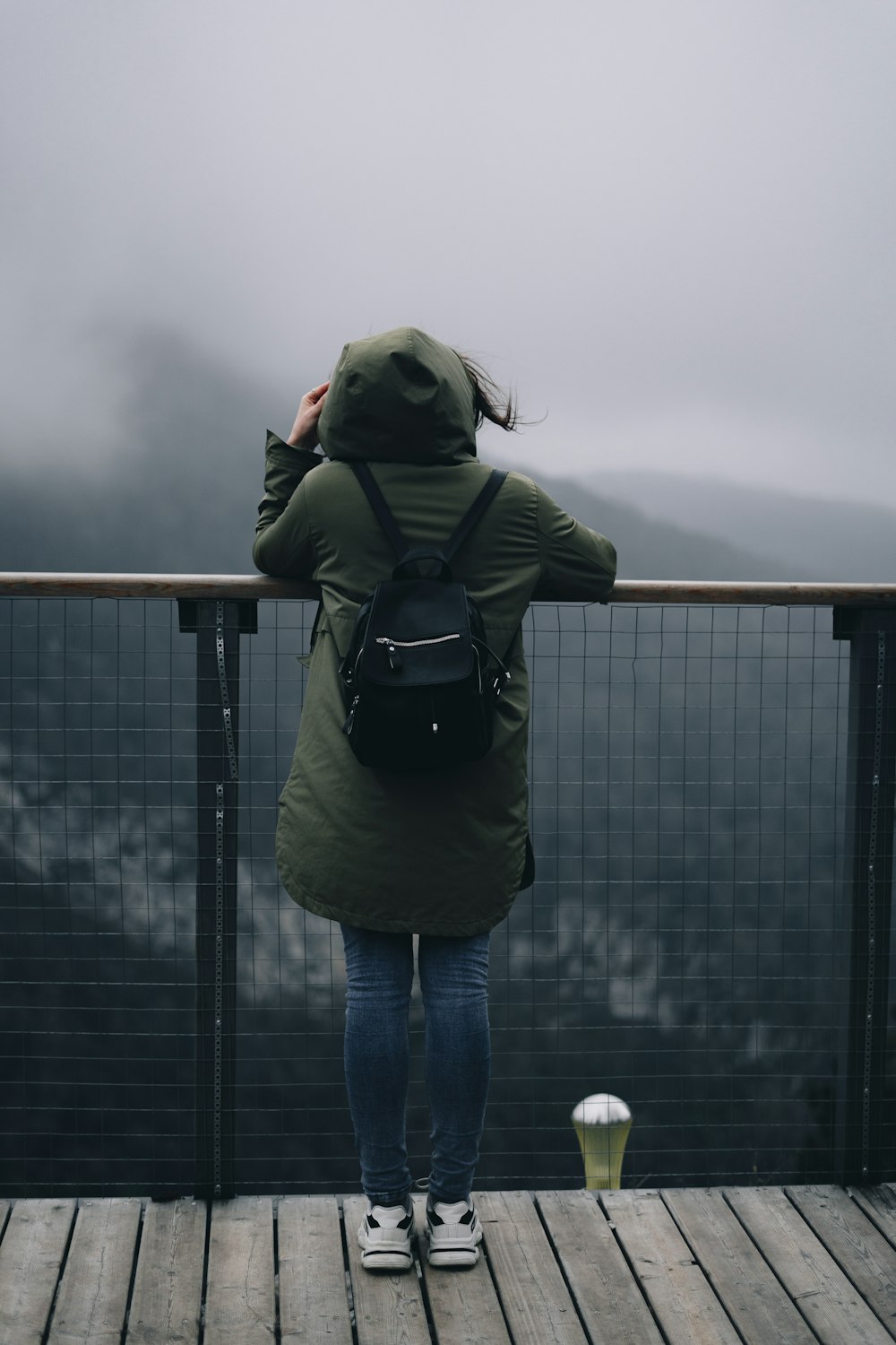 a person standing on a deck with a backpack