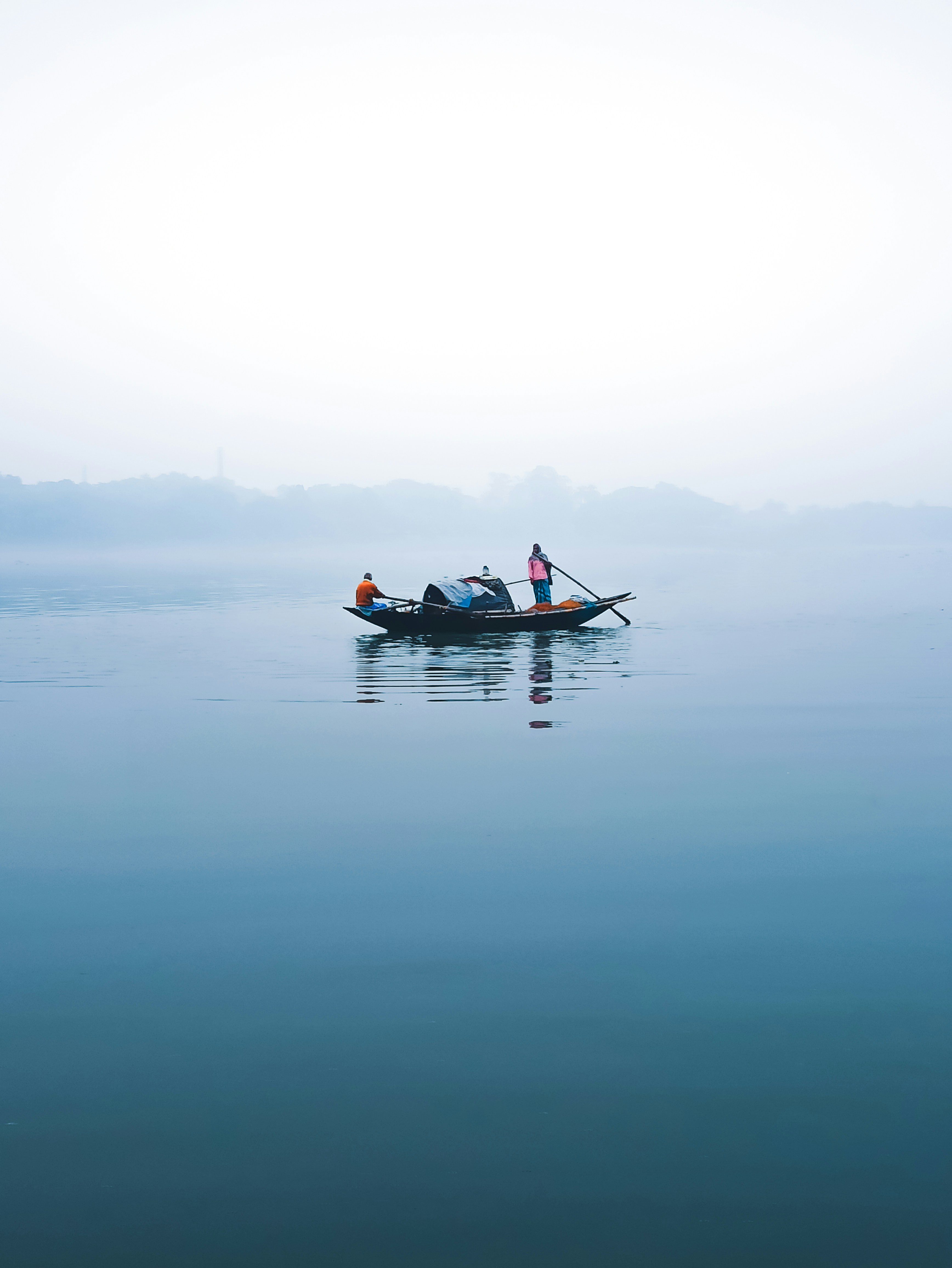 a person in a small boat in the middle of the water