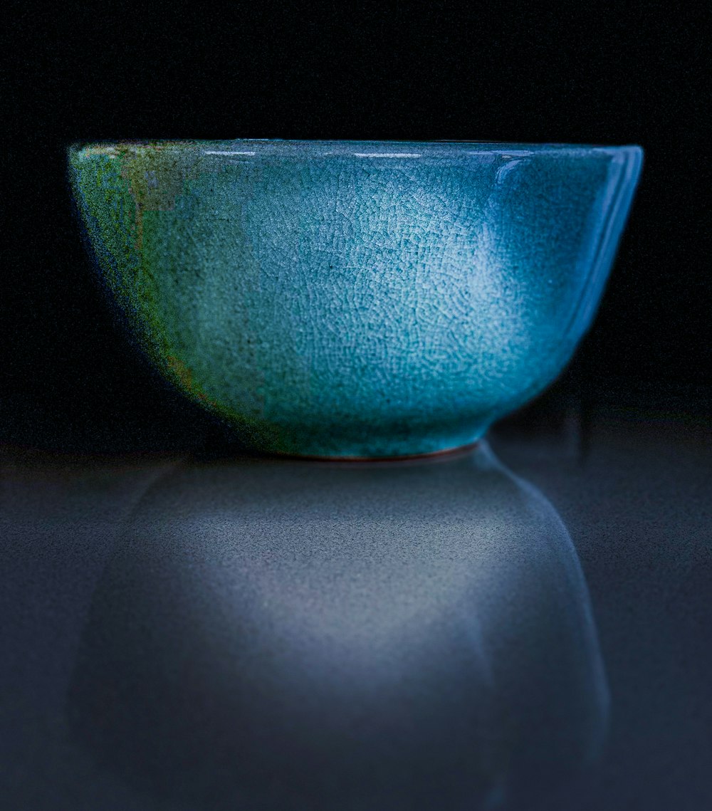 a blue bowl sitting on top of a table