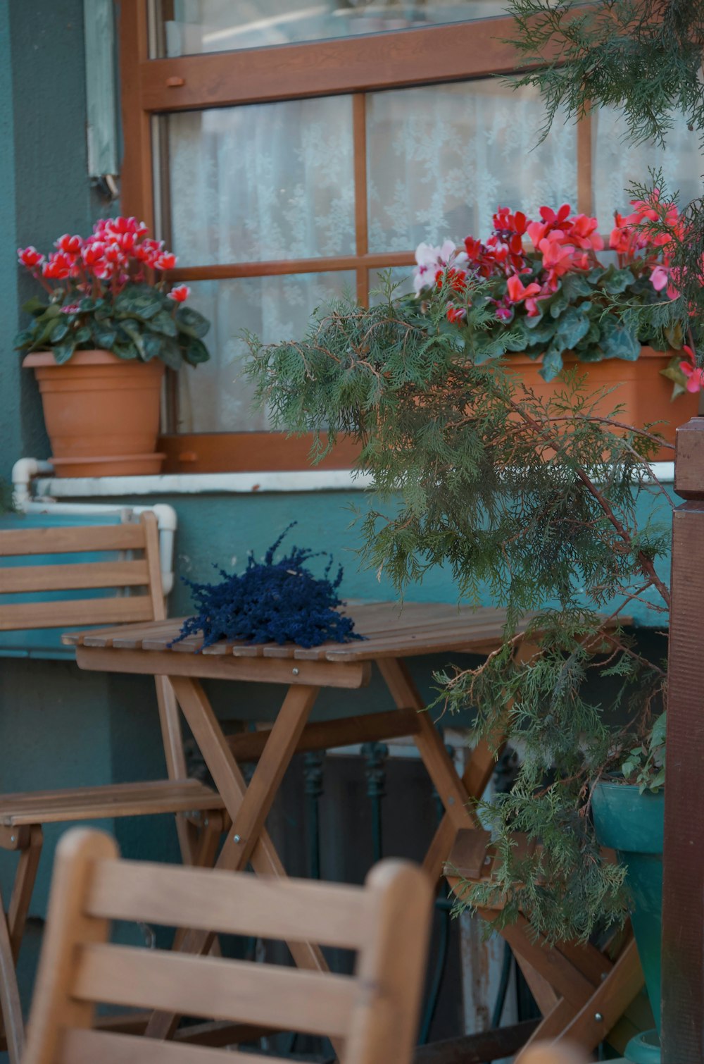 a wooden table and chairs outside of a building