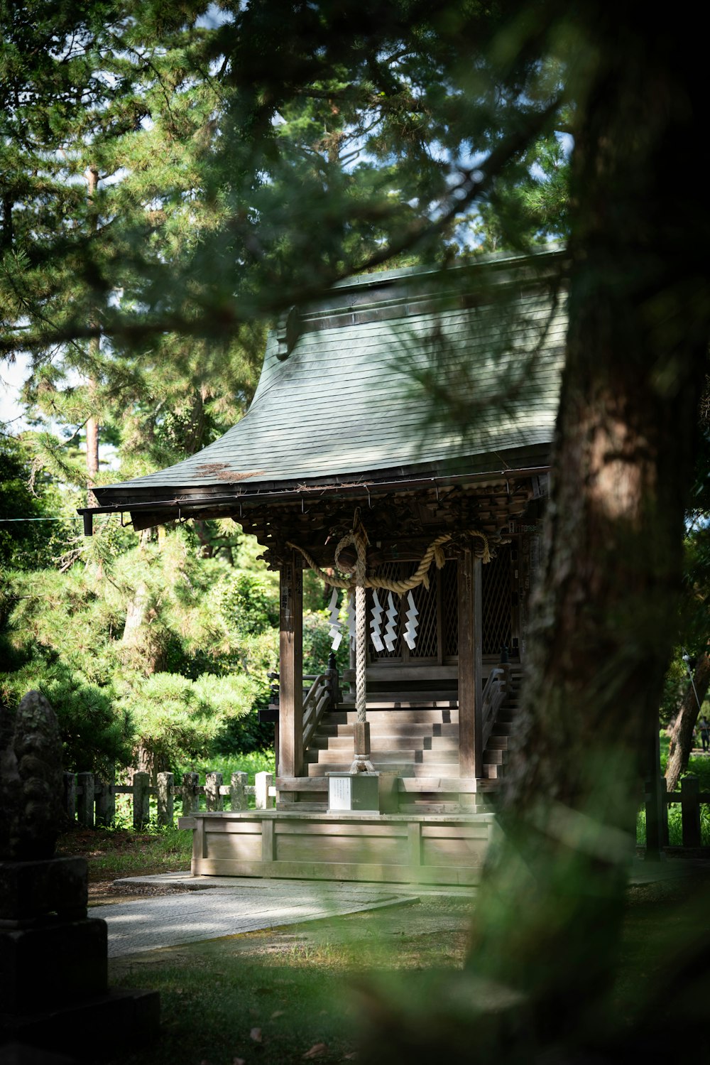 a gazebo in the middle of a park surrounded by trees