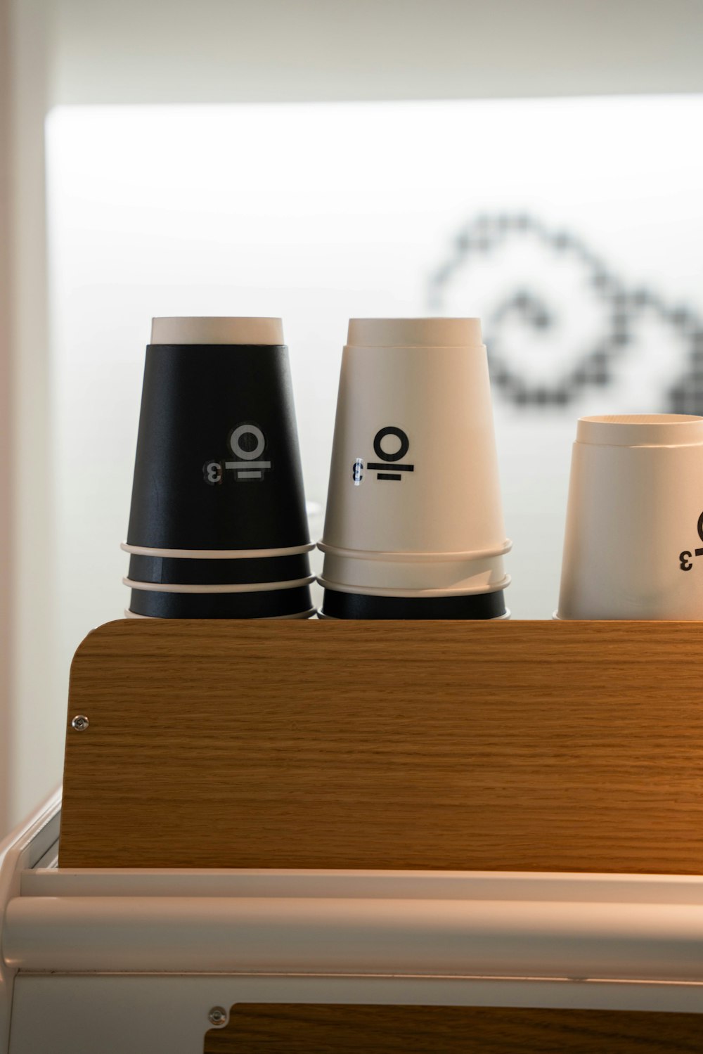 a close up of three cups on a shelf