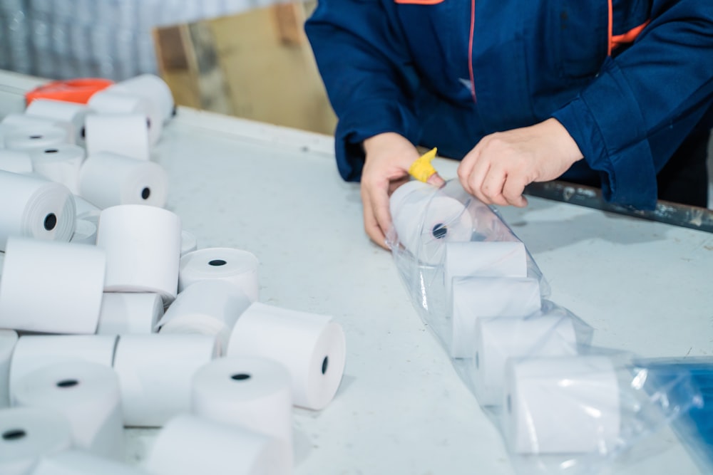 a person is putting a star on a roll of toilet paper