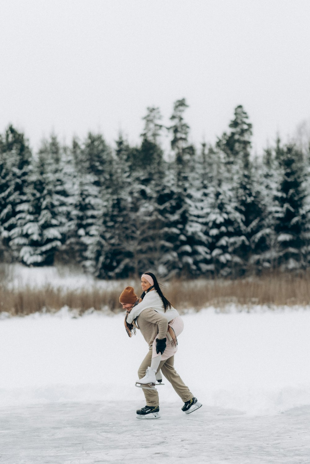 a woman walking across a snow covered field