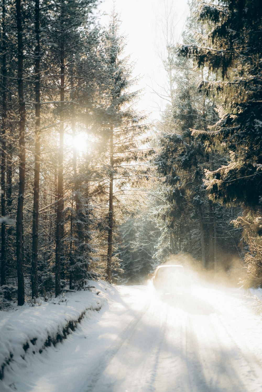 a car driving down a snow covered road