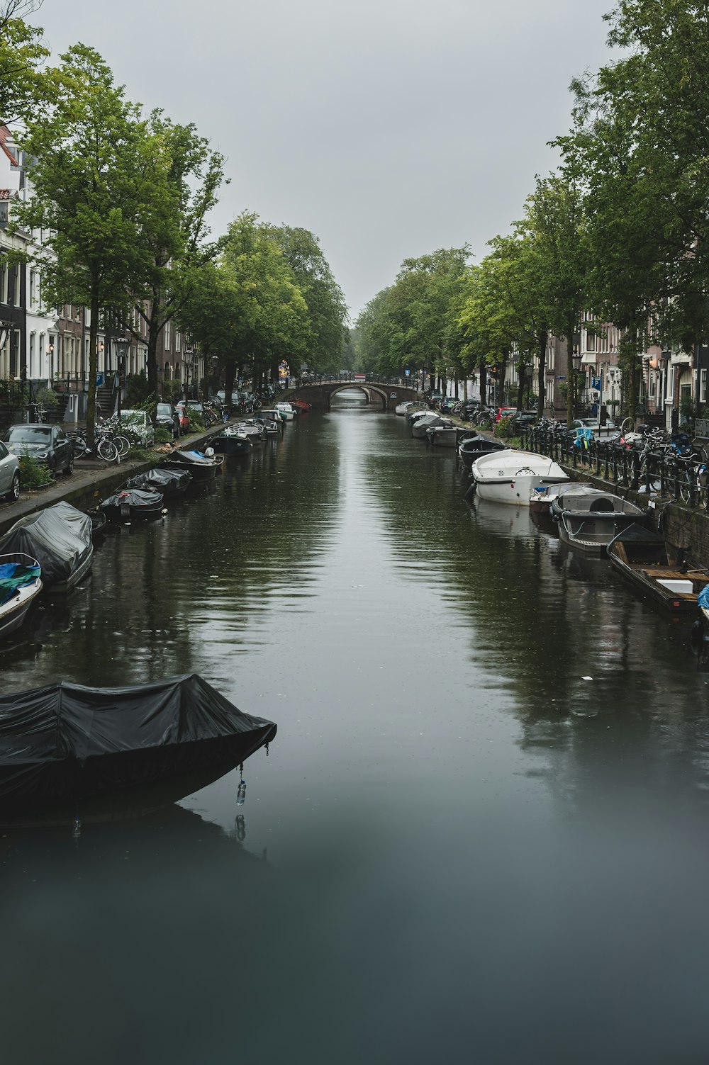 a canal with boats parked on both sides of it