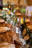 a wooden table topped with bottles of wine