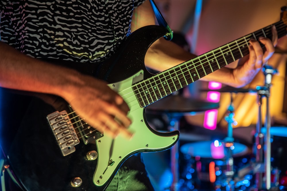 a close up of a person playing a guitar