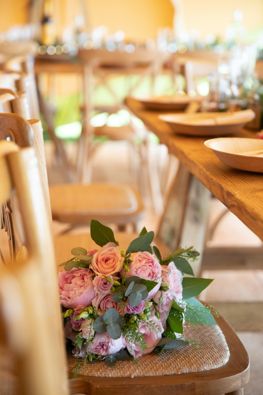 a bunch of flowers sitting on a chair at a table