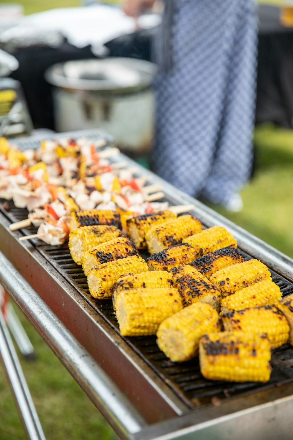 corn on the cob being cooked on a grill