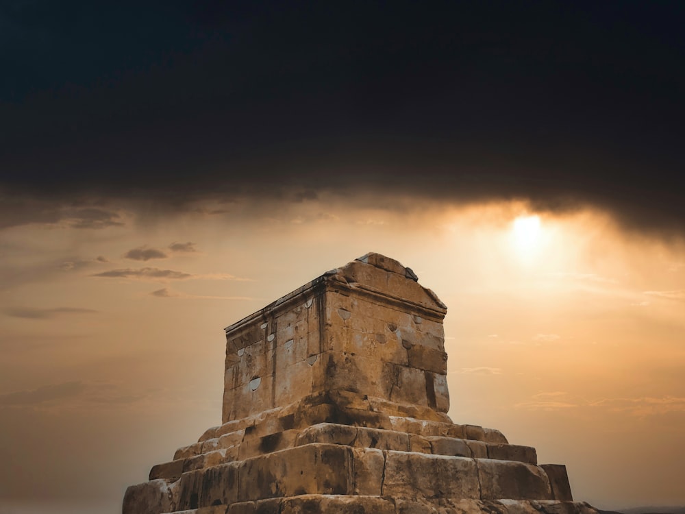 a large stone structure sitting under a cloudy sky