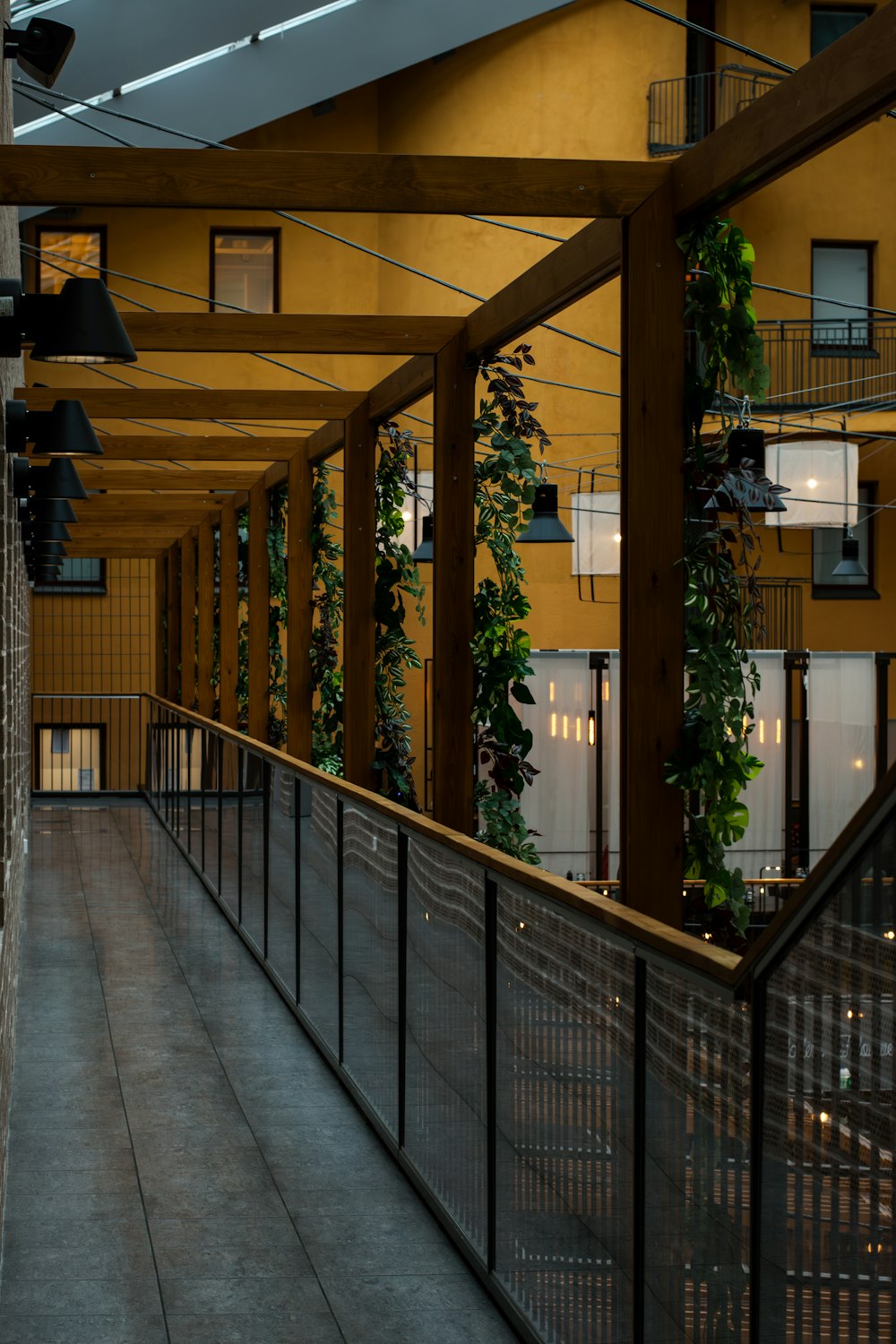 a walkway between two buildings with a clock on it