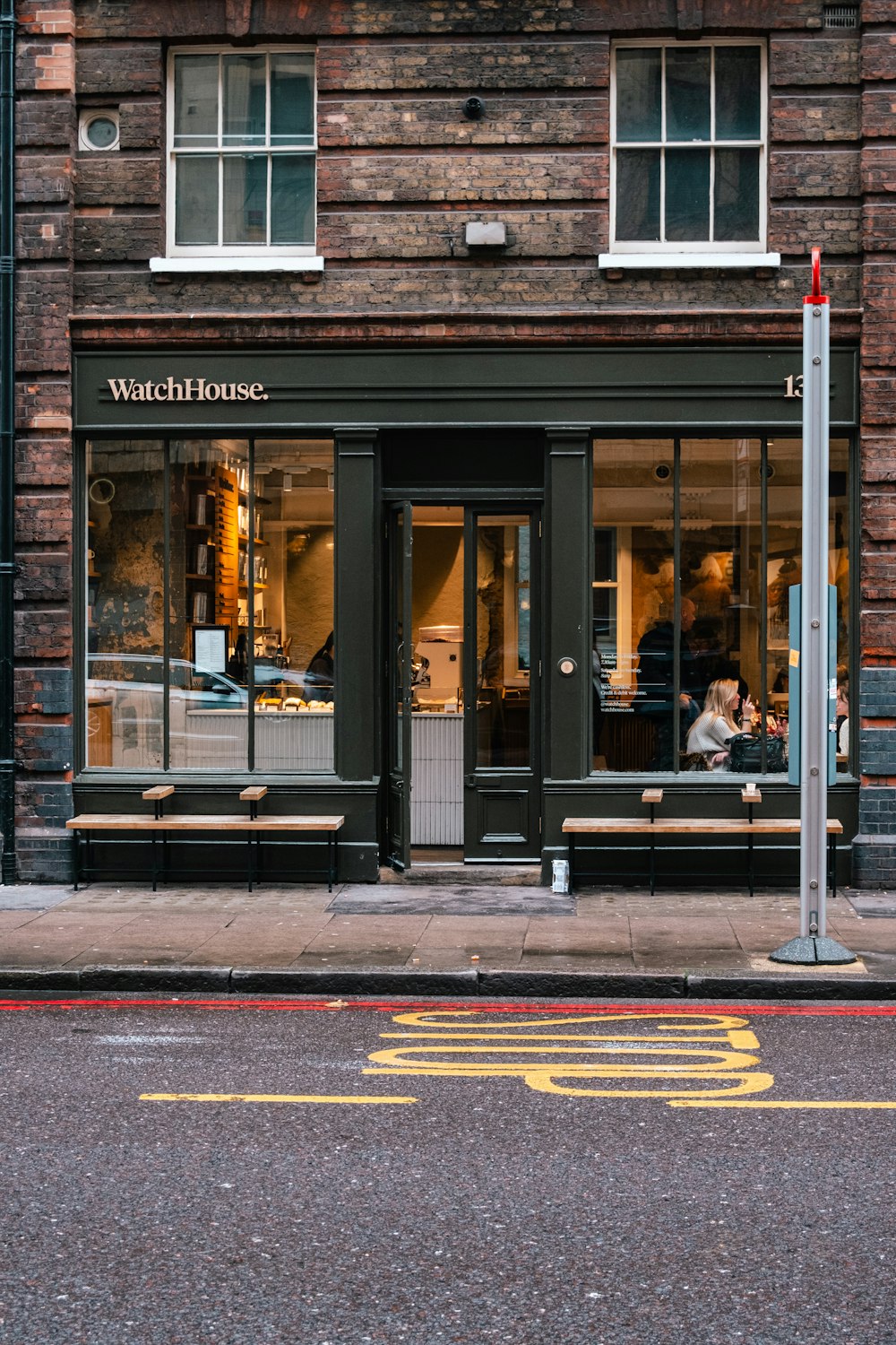 a store front with a clock on the side of it