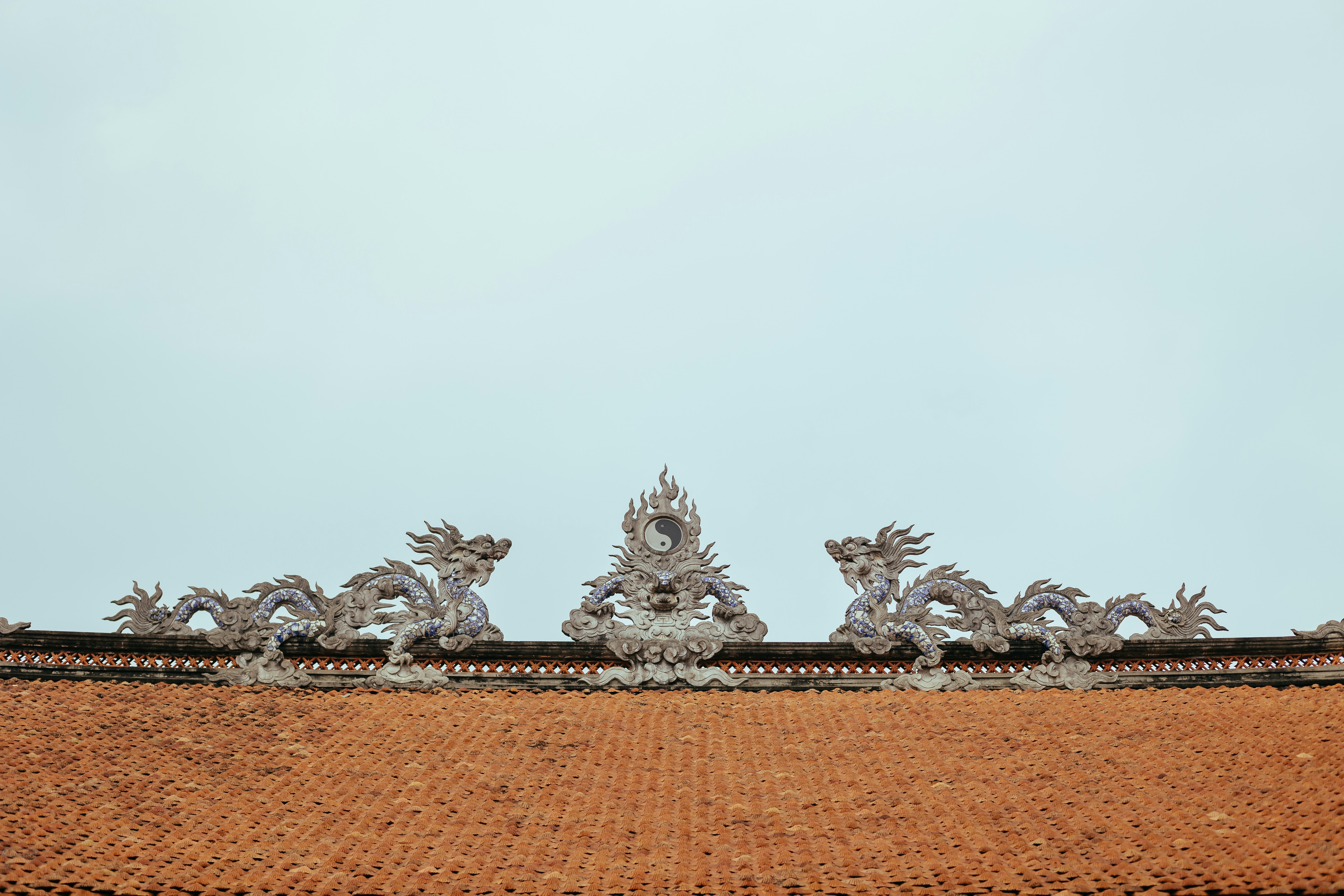 a close up of a roof with a sky in the background