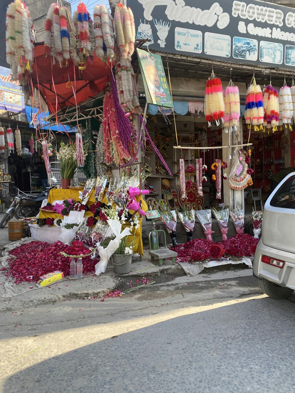 a car parked in front of a flower shop