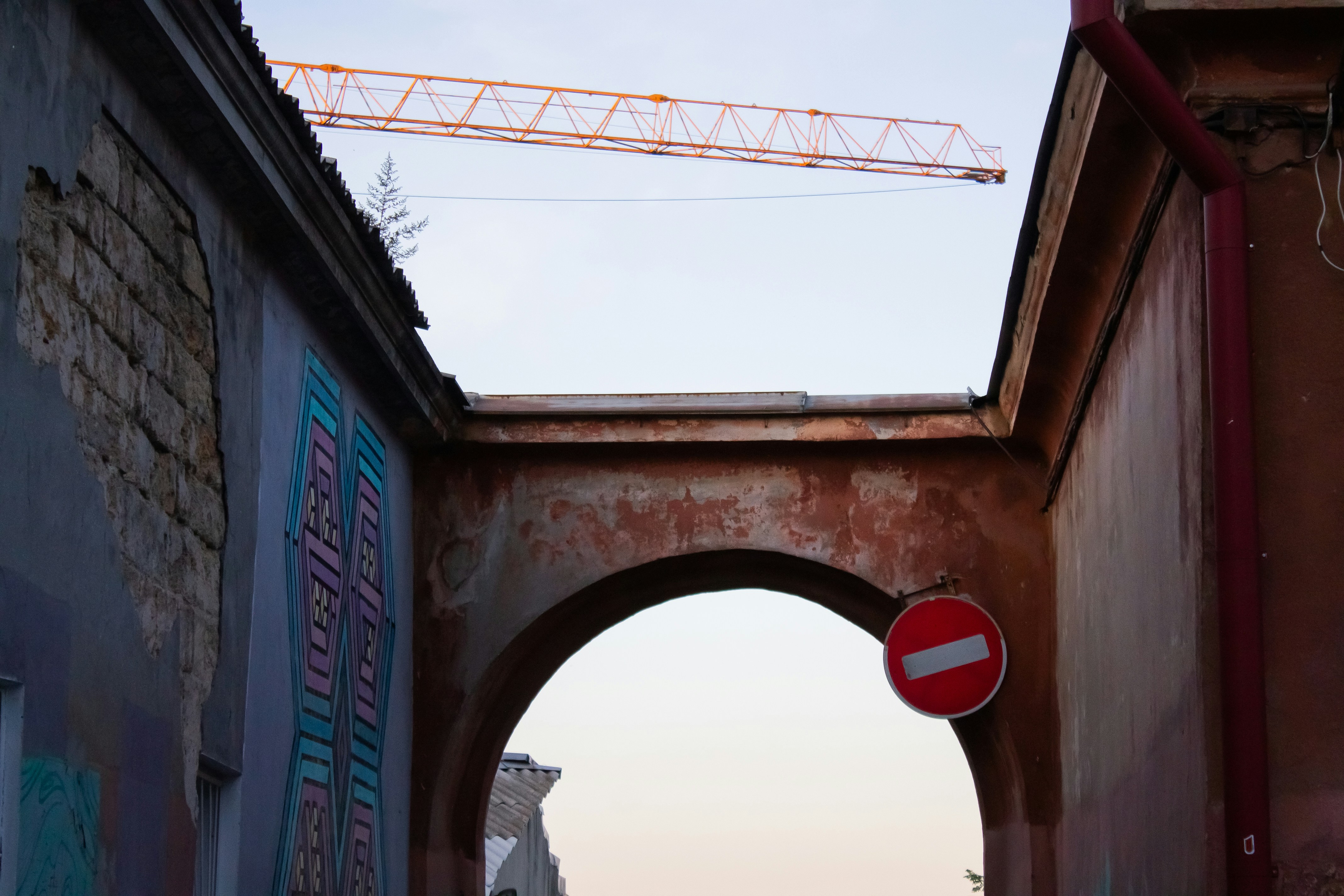 a red and white street sign sitting on the side of a building