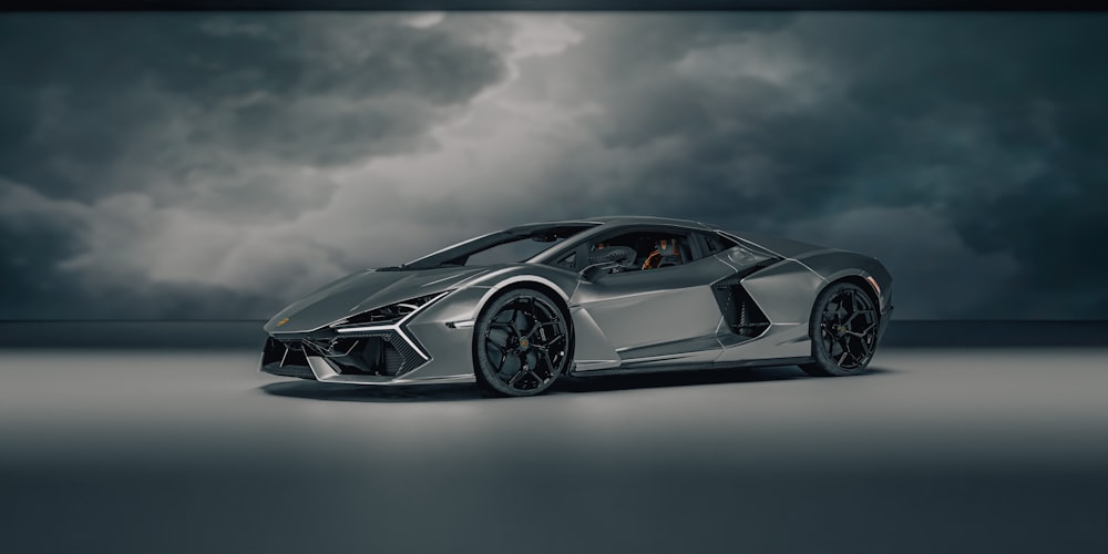 a silver sports car parked in a dark room