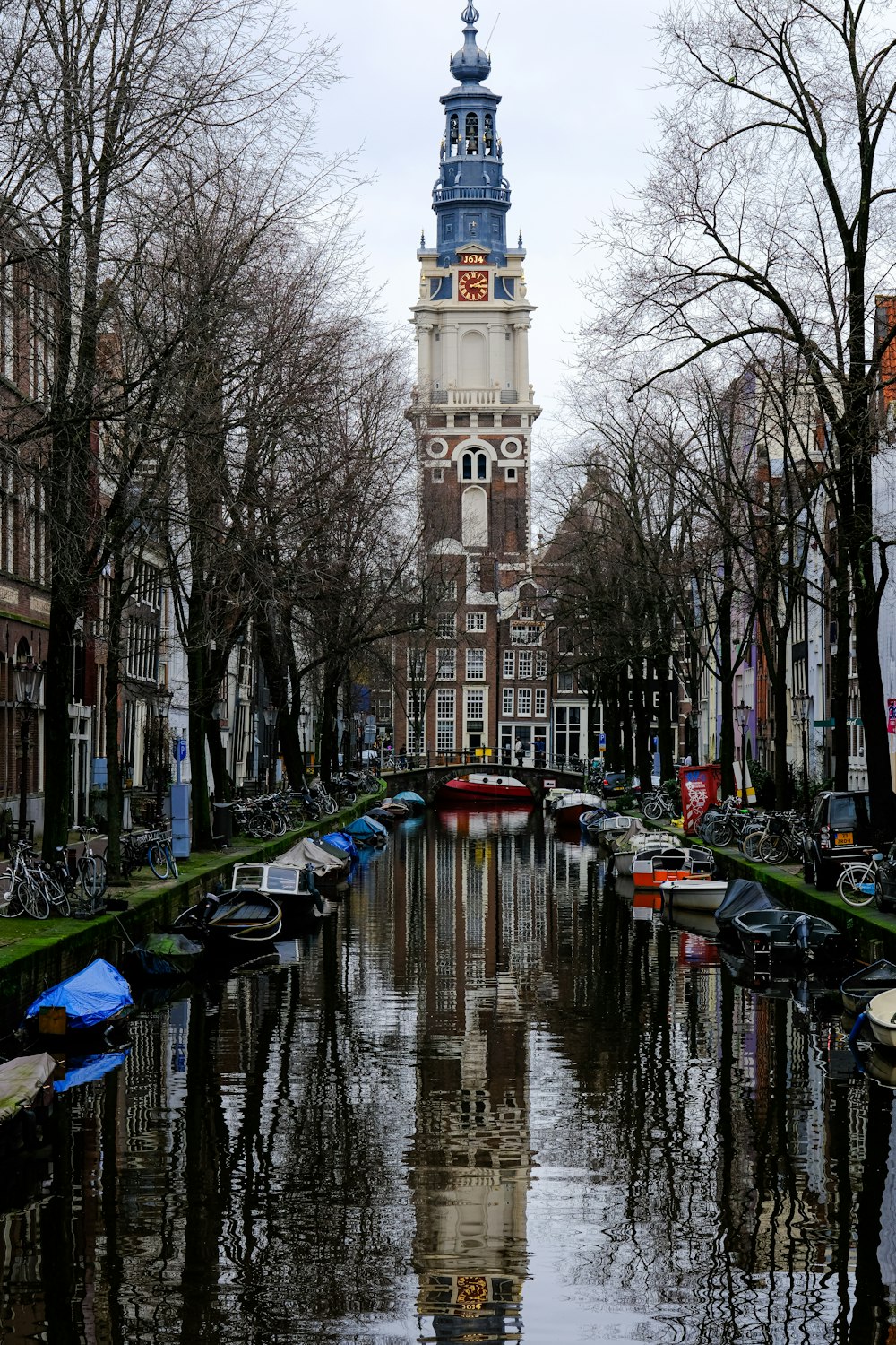 a canal with a clock tower in the background