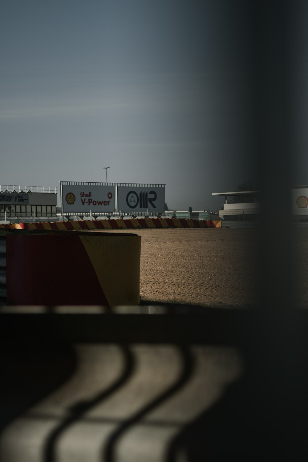 a view of a race track from behind a fence