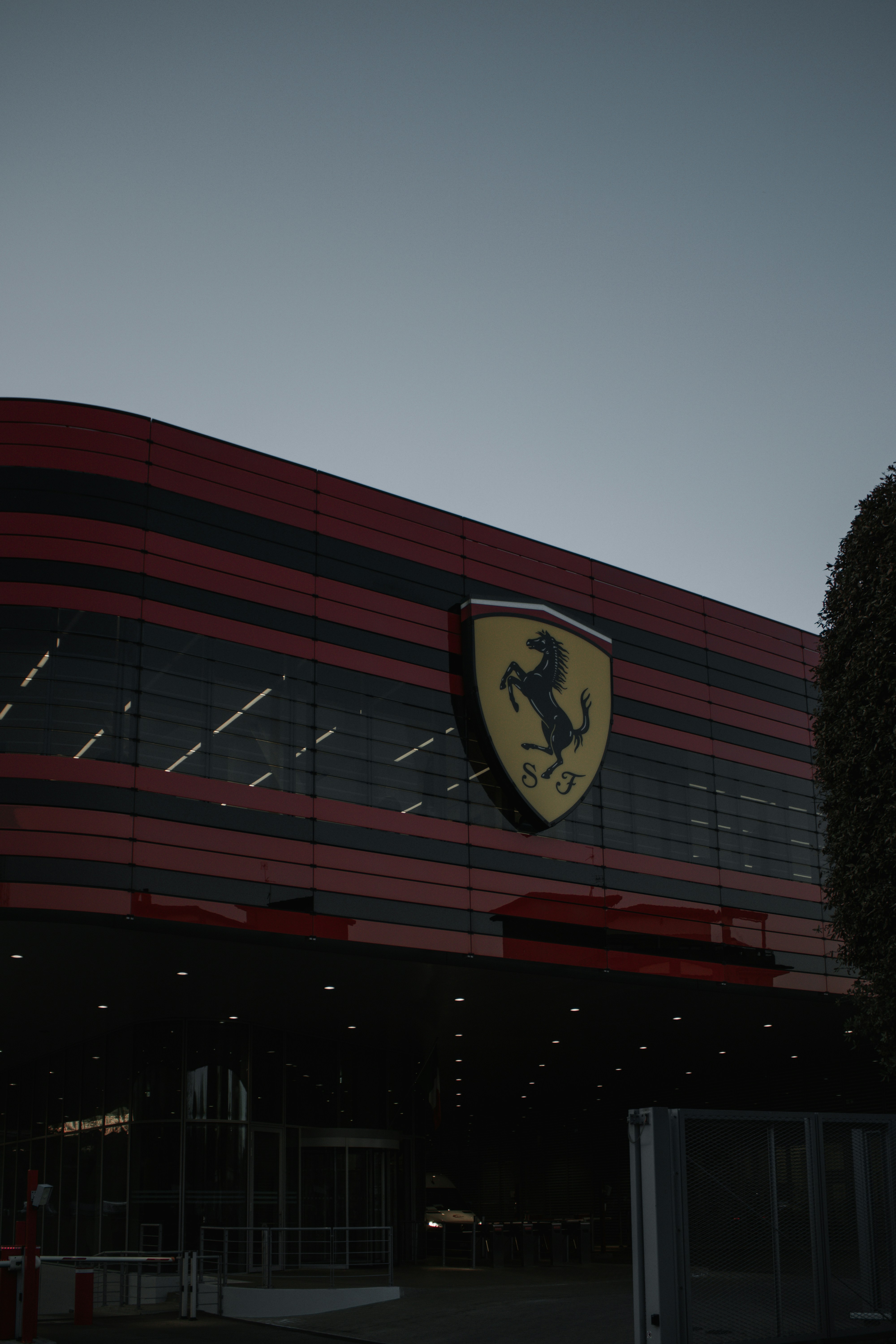 A red and black building with a ferrari logo on it photo – Free Grey ...