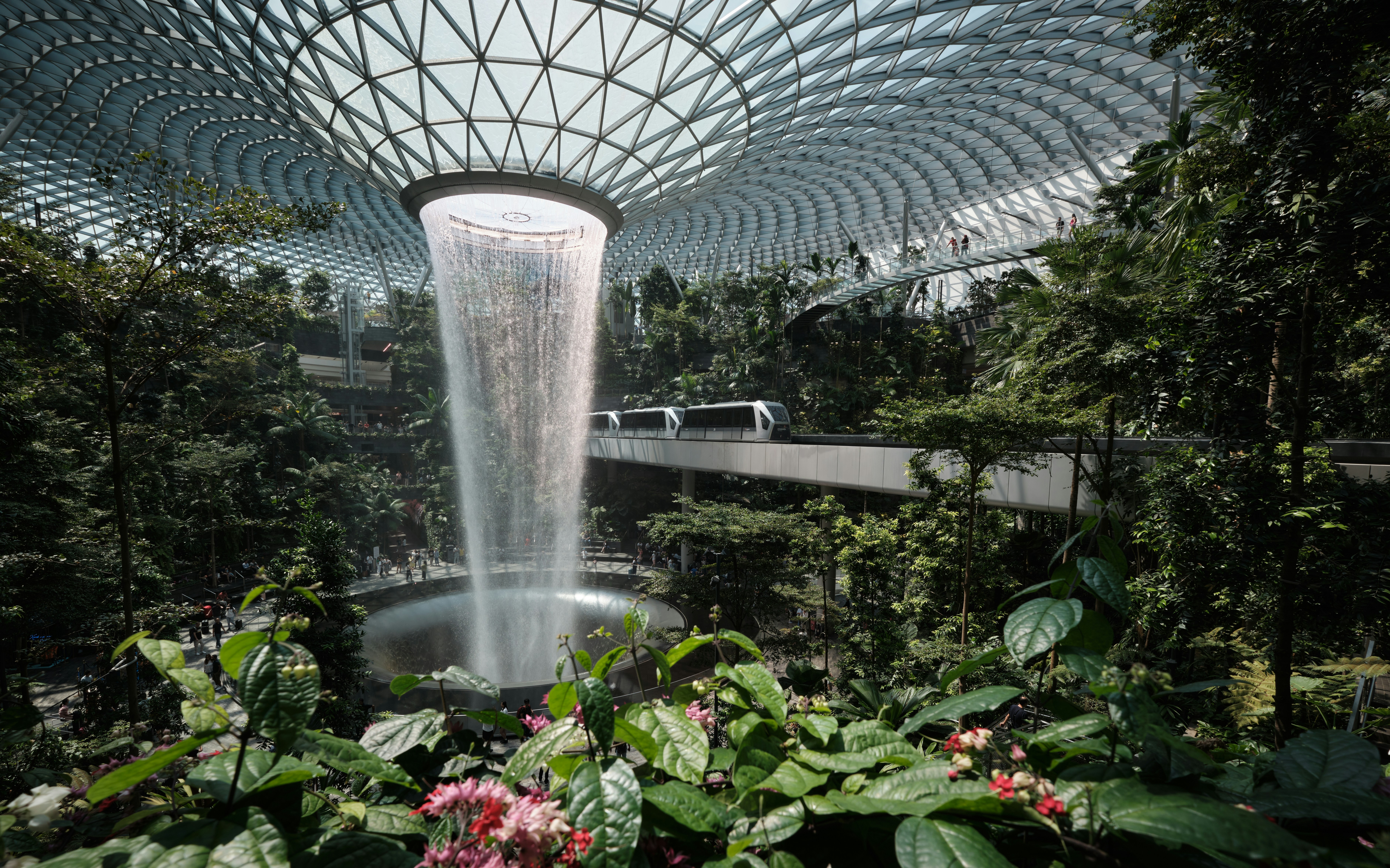 a waterfall in the middle of a tropical garden, the largest and tallest indoor waterfall in the world!