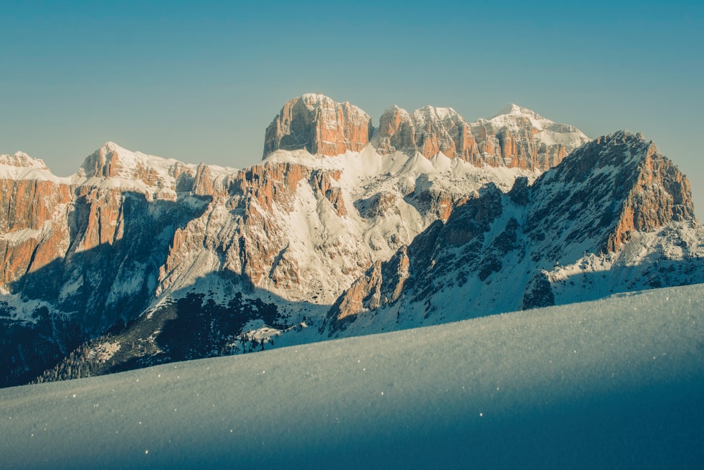 a snow covered mountain range with a clear sky