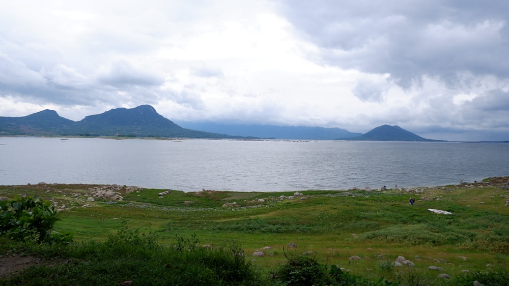 a large body of water with mountains in the background