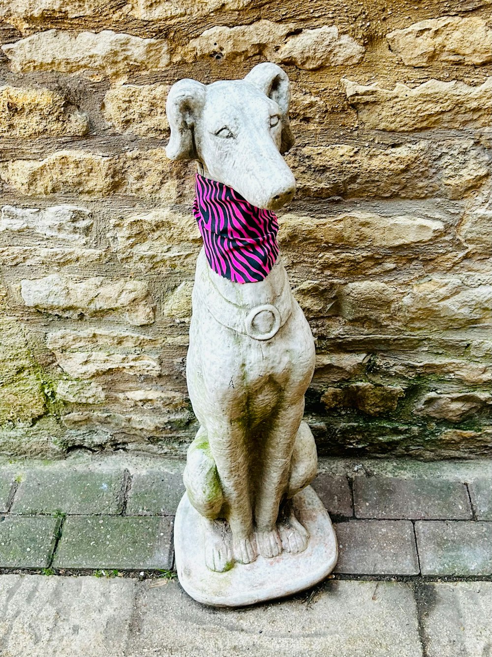 a statue of a dog wearing a scarf