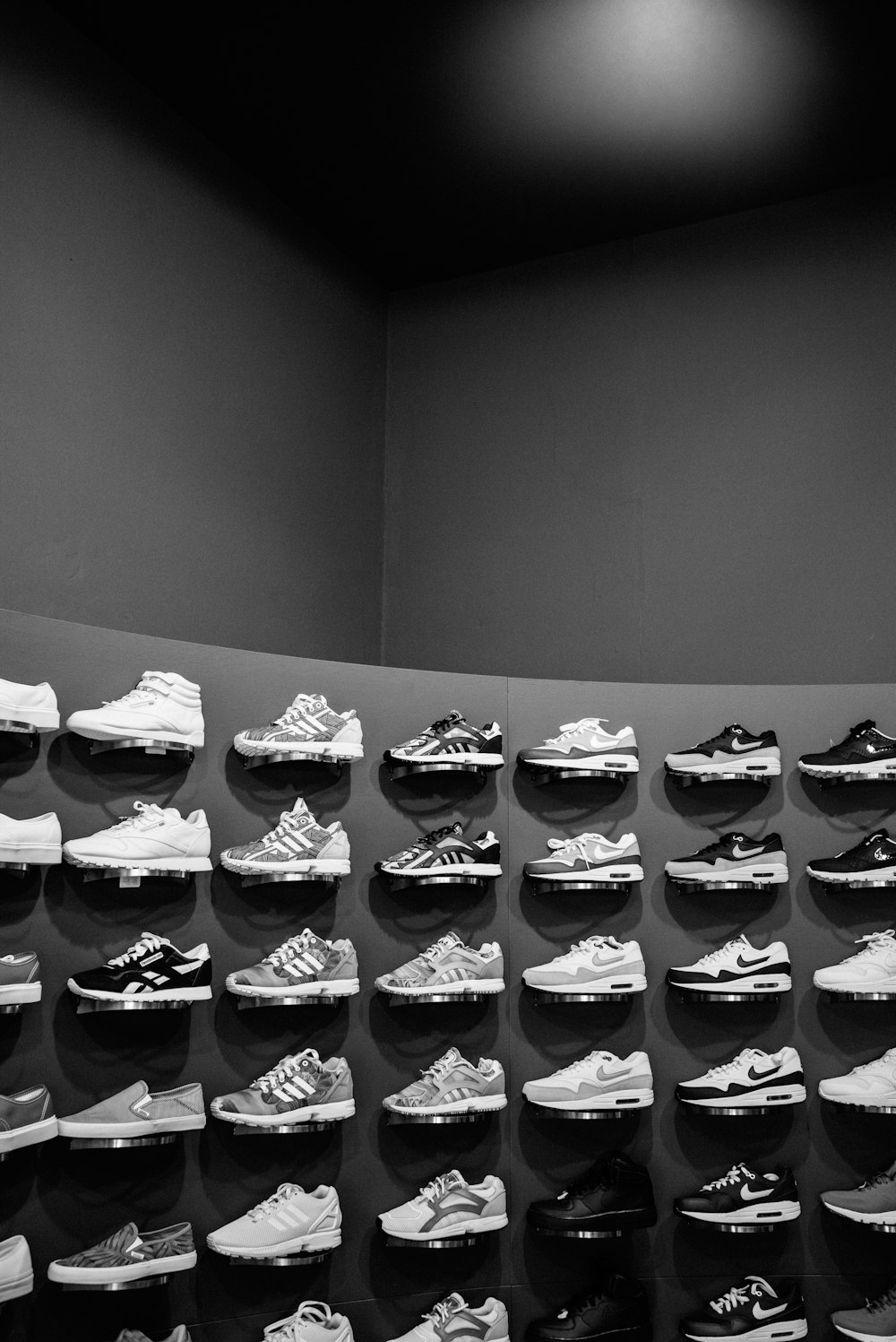 a large display of shoes in a black and white photo