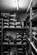 a black and white photo of a closet filled with boxes