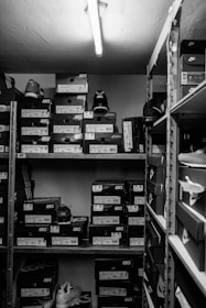 a black and white photo of a closet filled with boxes