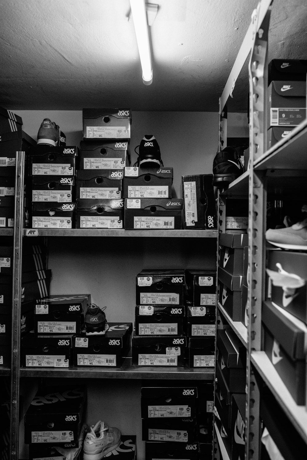 a black and white photo of a closet filled with boxes