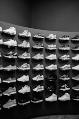 a large display of tennis shoes in a black and white photo