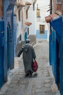 a man walking down a narrow alley way